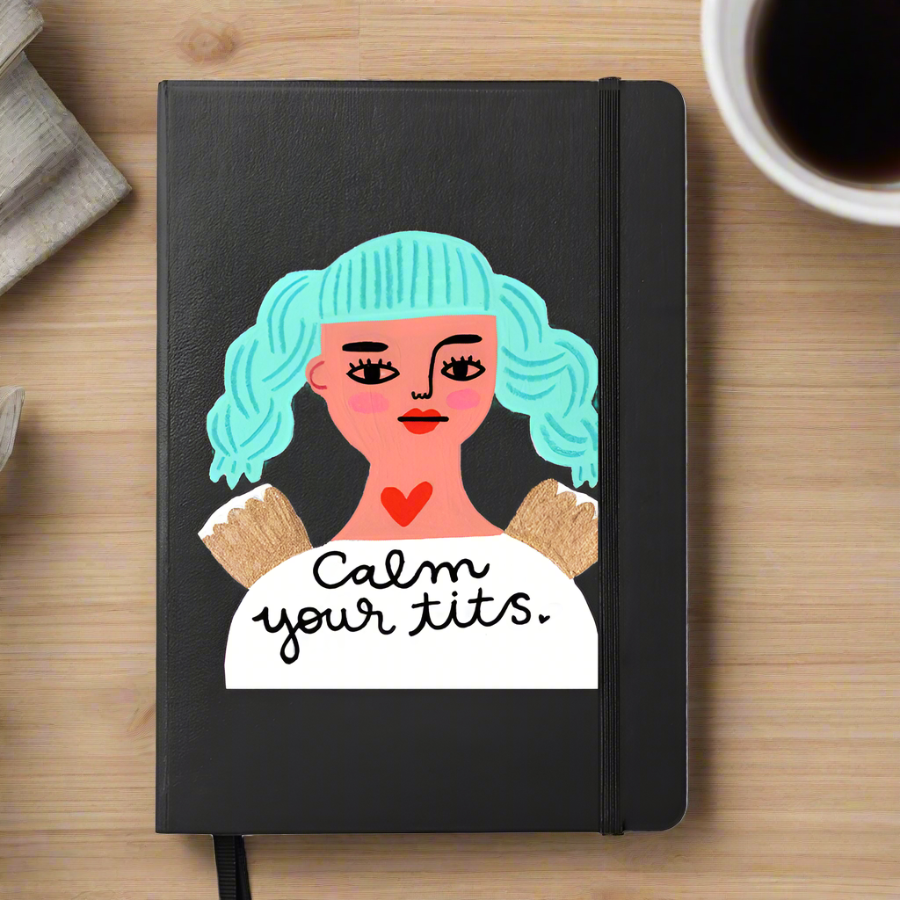 Calm Your Tits black notebook on a desk